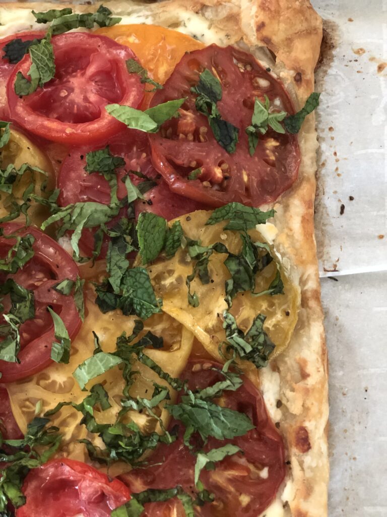 Fresh basil and mint top off the tart for more gorgeous color on your Heirloom Tomato Tart!