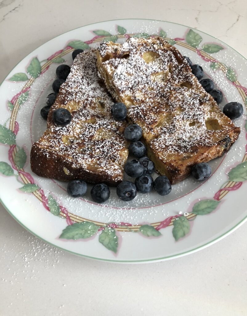 Dust Panettone French Toast with powedered sugar for snowy goodness