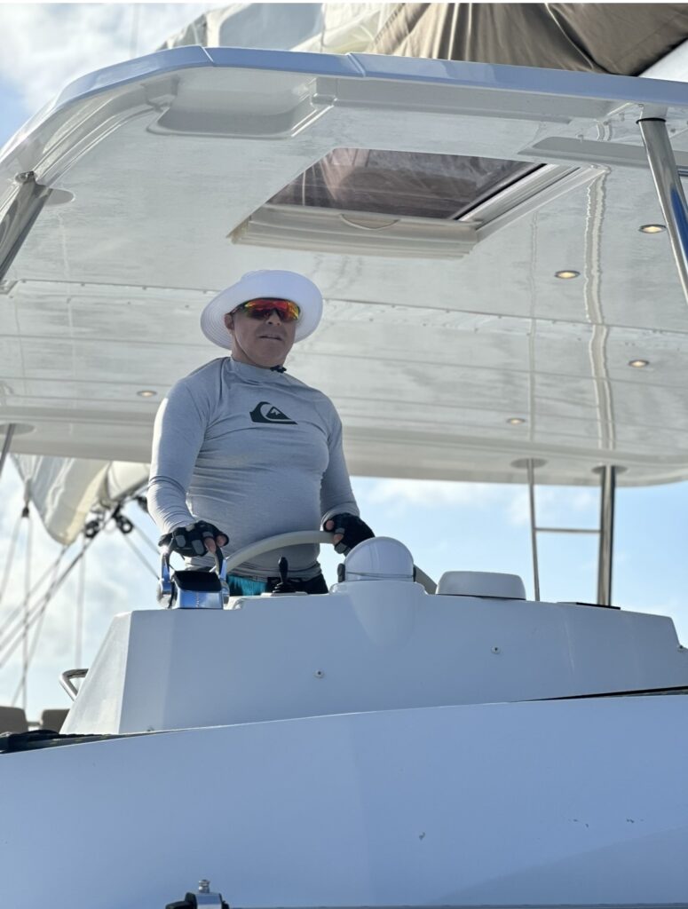 Siamak is wearing sun protective hat, shirt, sunglasses, lots of SPF and using sailing gloves to protect his hands when working the equipment sailing the British Virgin Islands